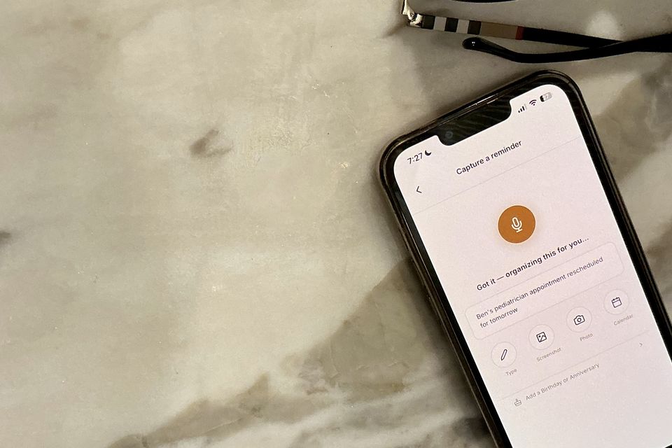 A phone on a marble kitchen counter showing Capture taking a spoken reminder