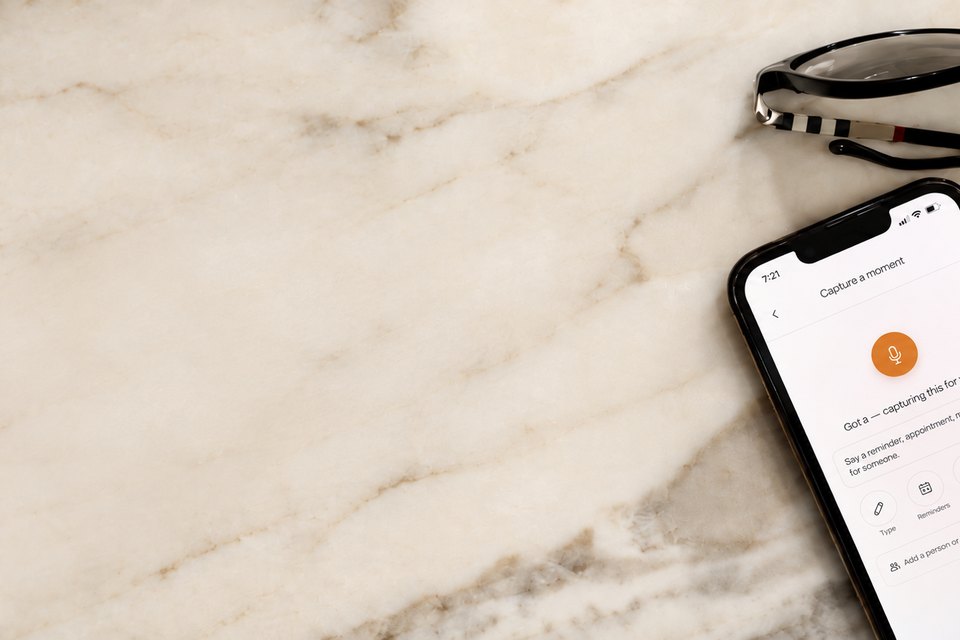 A phone on a marble kitchen counter showing Capture taking a spoken reminder